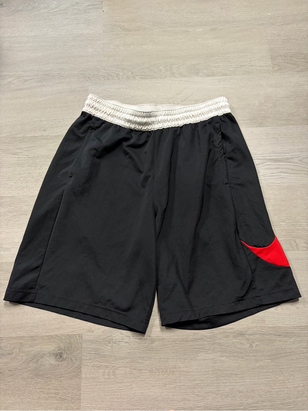 Nike Black Athletic Shorts With White Waistband And Red Swoosh Detail